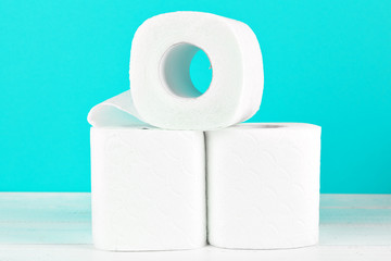 Toilet paper rolls on turquoise bright background
