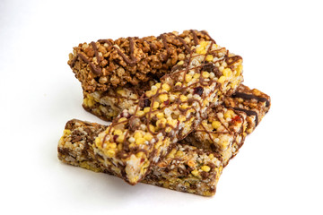 vegan dessert: several cereal bars with raisins and honey, isolated on white, short focus