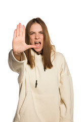 angry young woman shooting and showing stop hand on white background