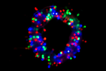 dark background with glowing multicolored lights in defocus, bokeh