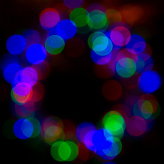 dark background with glowing multicolored lights in defocus, bokeh