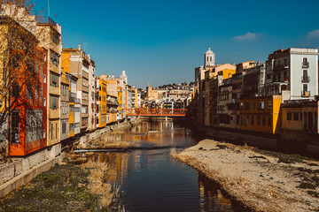 Colorful yellow and orange houses and famous house Casa Maso reflected in water river Onyar
