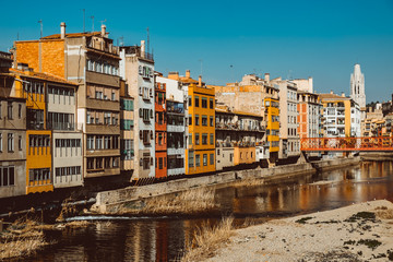 Colorful yellow and orange houses and famous house Casa Maso reflected in water river Onyar