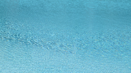 Clear blue water surface of swimming pool. Natural art background and template. 