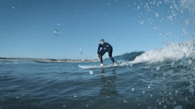 Young man surfing small wave in Portugal.