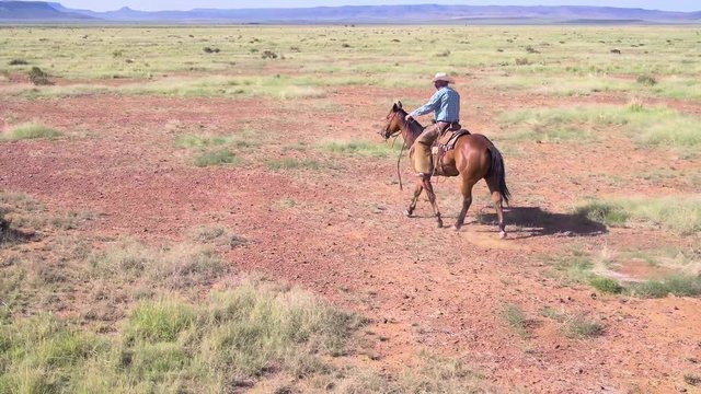 Cowboy Rancher Riding Through West, Aerial Pan In Slow Motion 4k