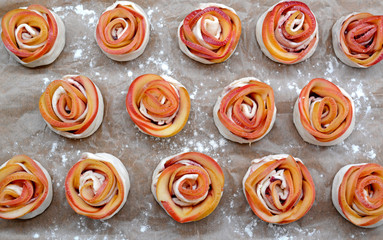 Baking tray with apple roses from puff pastry on table, closeup