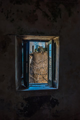 Looking out a Window in an Abandoned Medieval Village in Southern Italy