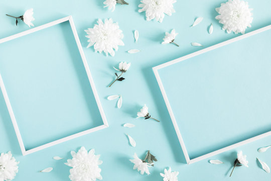 Beautiful flowers composition. Blank frame for text, white flowers on pastel blue background. Valentines Day, Easter, Birthday, Happy Women's Day, Mother's day. Flat lay, top view, copy space