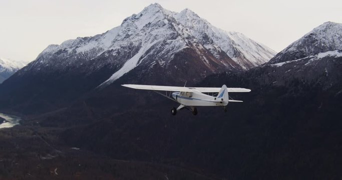 Airplane flies over Alaska wilderness, aerial