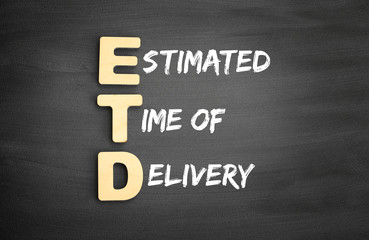 Wooden alphabets building the word ETD - Estimated Time of Delivery acronym on blackboard