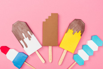 top view of handmade colorful origami ice cream isolated on pink