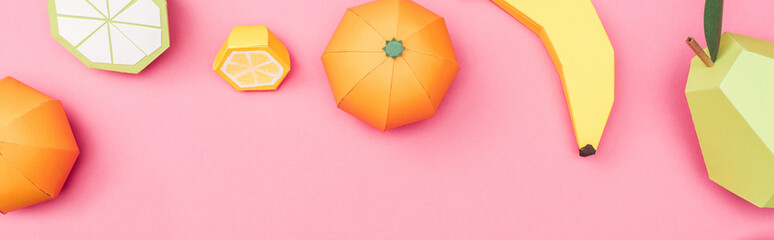 panoramic shot of multicolored handmade paper fruits on pink
