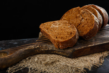 Home-made bread from rye flour, with seeds on old wooden Board