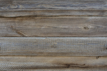 The texture of weathered wooden wall. Aged wooden plank fence of horizontal flat boards.