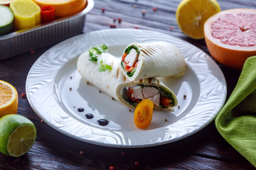 Caucasian tortilla roll with turkey tomatoes and cheese