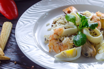 Steamed rice with shrimp, squid rings mussels and boiled eggs.