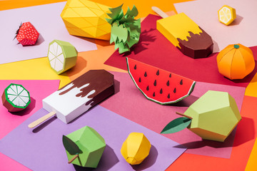 origami ice cream and handmade cardboard fruits on multicolored paper