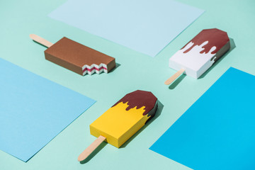 handmade origami ice cream on blue and turquoise paper