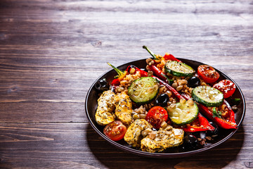 Pepper stuffed with groats and vegetables and grilled chicken strips