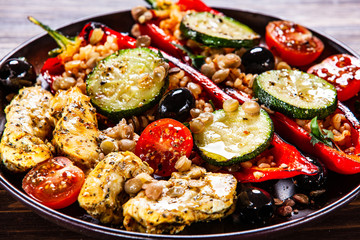 Pepper stuffed with groats and vegetables and grilled chicken strips