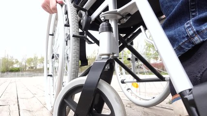 43 year old male sitting on a wheelchair in the park