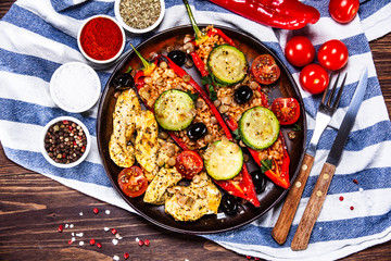 Pepper stuffed with groats and vegetables and grilled chicken strips