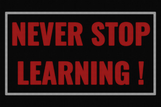 Never Stop Learning  word on dark screen