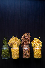 bottles contain grains like green gram,brown chickpeas,yellow checkpeas and 