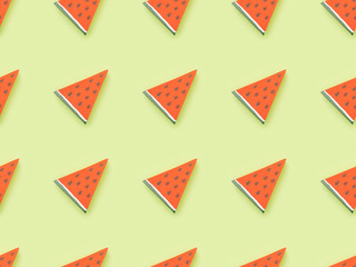 top view of pattern with handmade red paper watermelon slices isolated on green