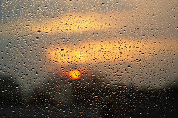 Raindrops on the glass and sunset. Weather forecast.