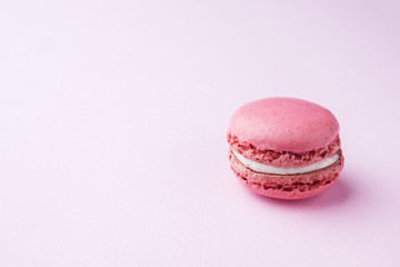 Pink dessert macaron or macaroons on pink background. Selective focus. Copy space