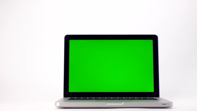Slide shot of Laptop computer with a key green screen isolated on white background. 4k Resolution