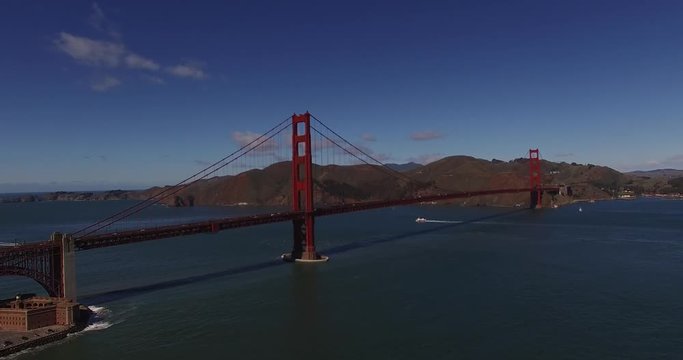 San Francisco Golden Bridge DOLLY Right - DRONE AERIAL on clear sky with  traffic on bridge.