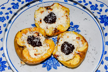Apples baked with cottage cheese and decorated with chocolate and coconut chips.