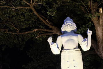 sculpture of a hindu deity with four arms and several faces