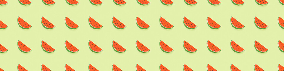 panoramic shot of pattern with handmade paper watermelon slices isolated on green