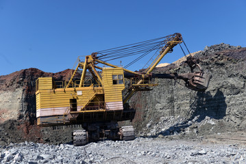 excavator works with granite or ore at opencast mining