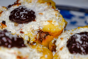 Apples baked with cottage cheese and decorated with chocolate and coconut chips.