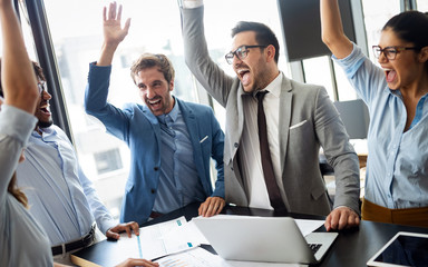 Business team celebrating a good job in the office