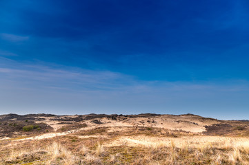 Landscape with desert dunes and blue sky