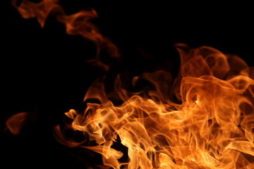 Fire burning on dark background for abstract flame texture and graphic design purpose