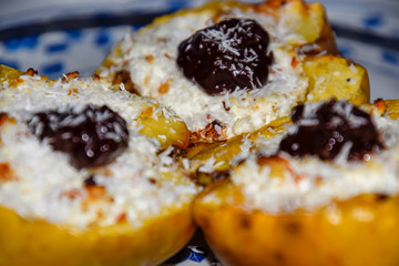 Apples baked with cottage cheese and decorated with chocolate and coconut chips.