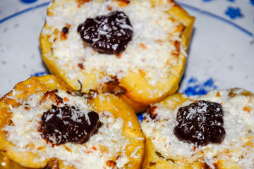Apples baked with cottage cheese and decorated with chocolate and coconut chips.