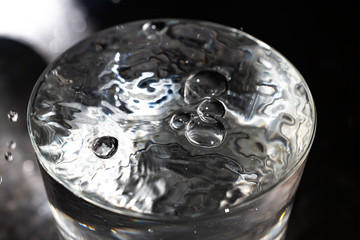 Clear water bubbles floating in transparent glass, Close up & Macro shot, Selective focus, Healthy Drink concept