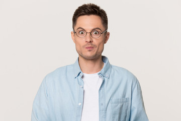 Doubtful Caucasian man isolated on grey background thinking