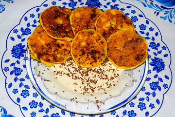 Cheesecakes with sour cream and chocolate chips on plate.
