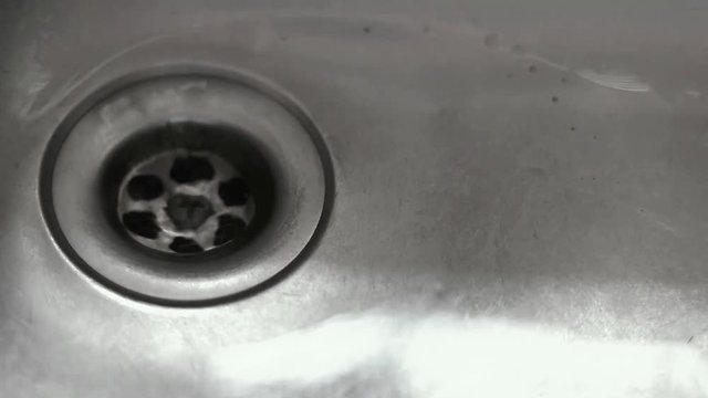 water draining on stainless sink