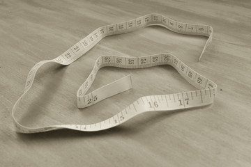 Tape measure. Healthy or fashion concept. Macro monochrome photo.