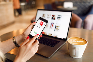 Women hands using smartphone and laptop computer for online shopping. Payment Detail page display.